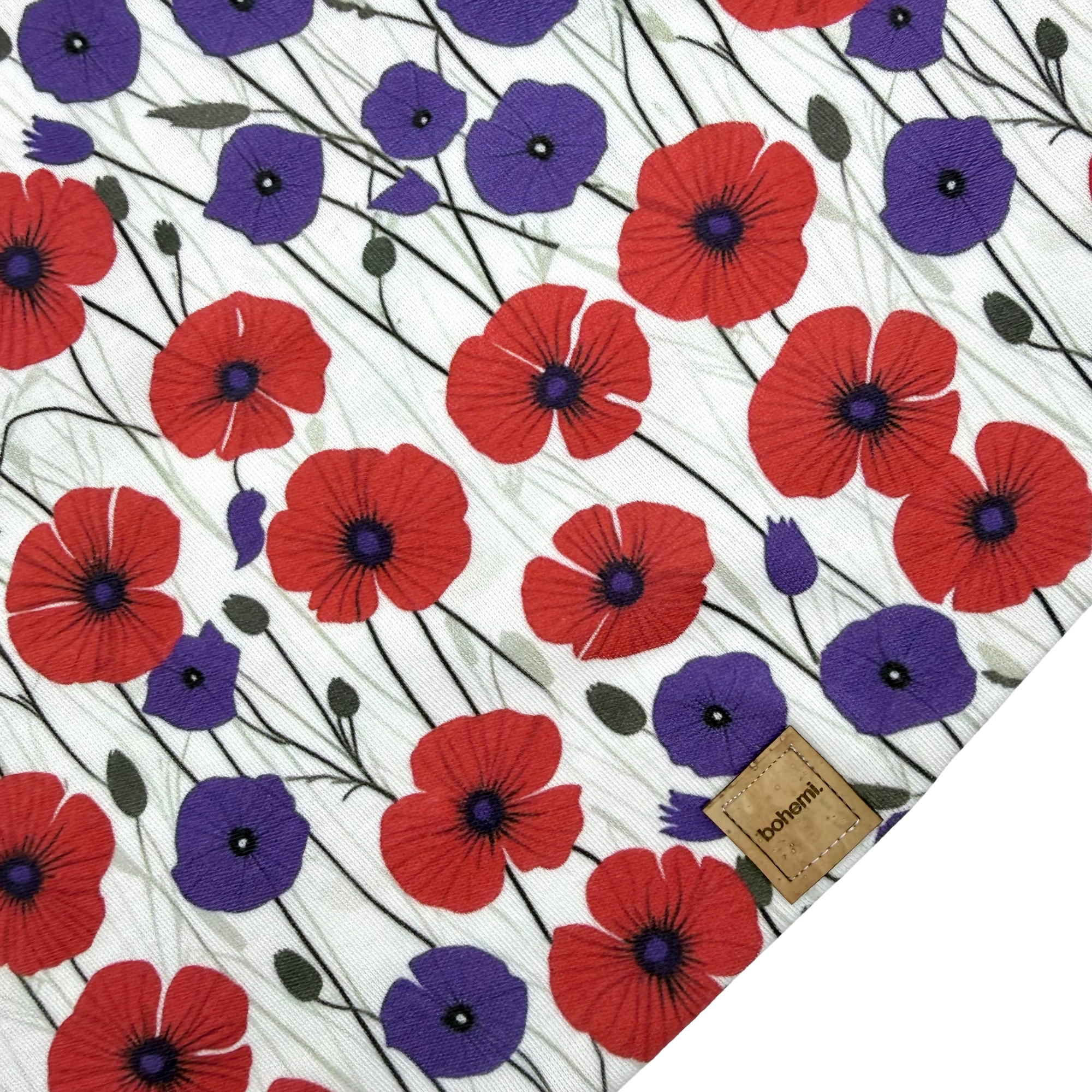 Patterned fabric with red and purple poppy flowers on a white background, featuring the brand 'bohemi'.