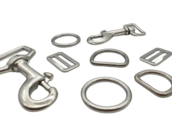 stainless sell silver snap clip, dring, o ring and tri glides on white background